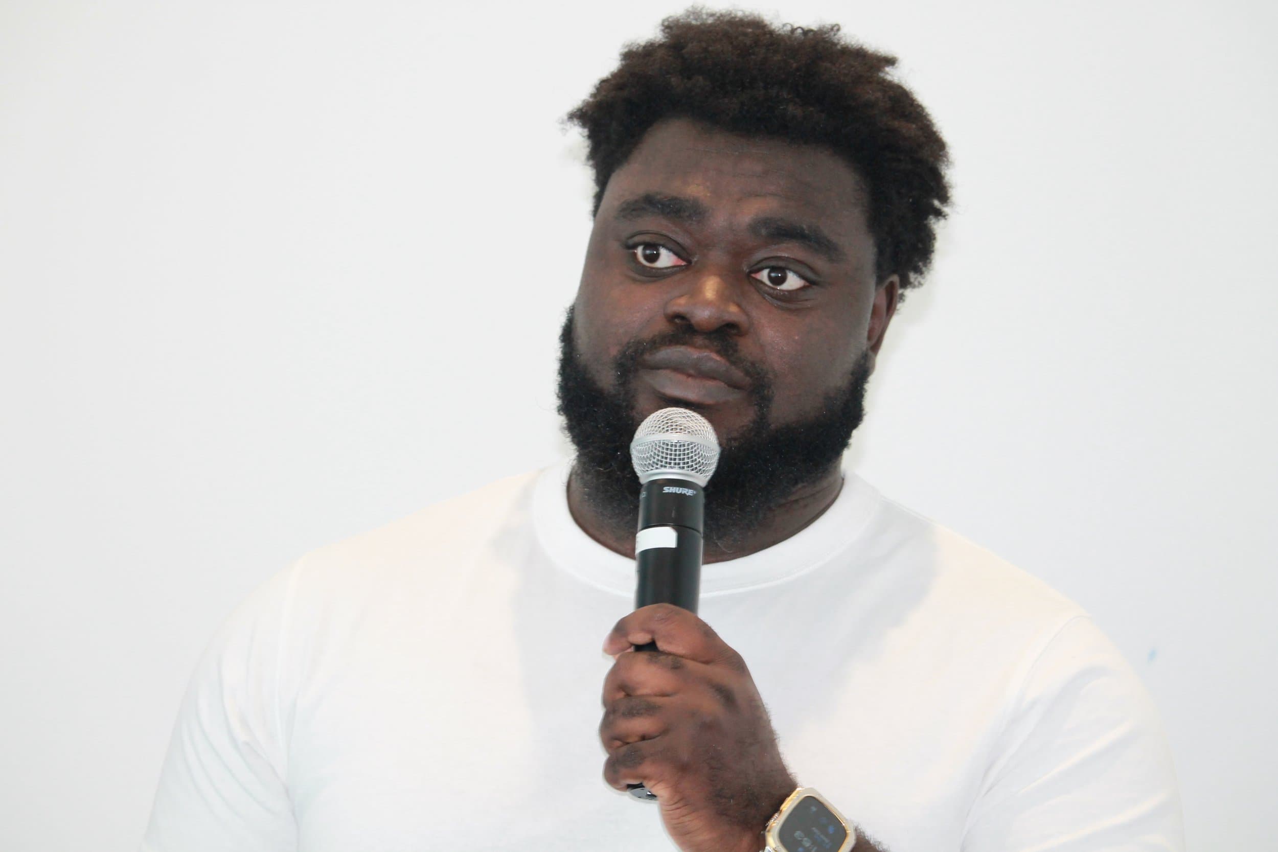 Jeremy Ampofo holding a microphone